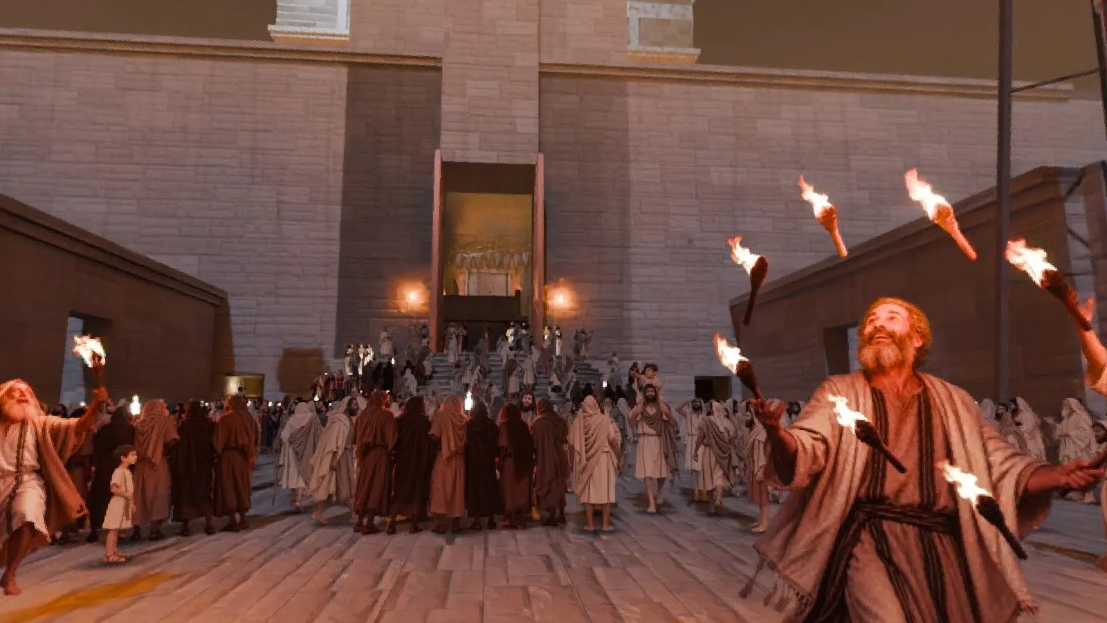 Ezras Nashim at night lit by torches, a man juggling torches